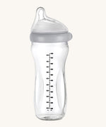 The Haakaa Generation 3 Glass Baby Bottle 300ml in grey, on a cream background
