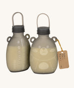 The Haakaa Happii Bear Milk Storage Bag, with one showing the easy to read measurements on the back to keep track of consumption, and the other side is of the Happii Bear print
