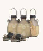 Three Haakaa Happii Bear Milk Storage Bags with 2 rolled up bags in front to show how durable, flexible and compact the storage bags are