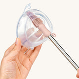 The Haakaa Silicone Cleaning Brush being used to clean the Ladybug milk collector