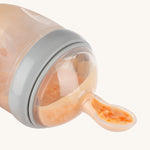 Food in the spoon part of the Haakaa Generation 3 Silicone Bottle Feeding Spoon Head, to show how easy it is for a baby or toddler to eat from