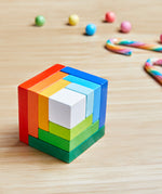 A wooden 3D Haba rainbow cube arranging puzzle on a table