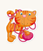 A orange cat with pink wool from the Haba animal puzzle set on a cream background
