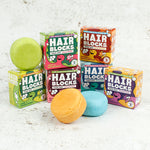 Hair Blocks Solid Shampoo Bars with their cardboard boxes