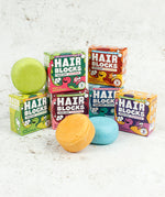Hair Blocks Solid Shampoo Bars with their cardboard boxes