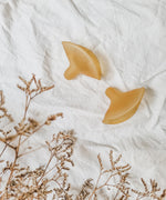 Hevea Natural Rubber Nipple Shields - 2 Pack side view on a white cotton sheet.