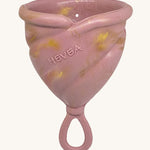 Hevea LOOP Menstrual Cup Size 3 - Golden Rosewood, a pink rubber menstrual cup with gold flecks and a loop stem.
