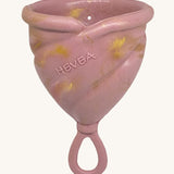Hevea LOOP Menstrual Cup Size 3 - Golden Rosewood, a pink rubber menstrual cup with gold flecks and a loop stem.