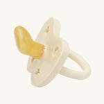 Hevea Orthodontic Baby Pacifier - 0-3 Months in Milky White on a cream background