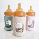 Hevea Glass Baby Bottle Wide Neck With Rubber Sleeve - 150ml in Seafoam Blue, Sand and Powder Pink