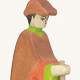 A close up of the wooden Holztiger wooden shepherd figure showing the hand painted detail on the face and the brown cap on the head