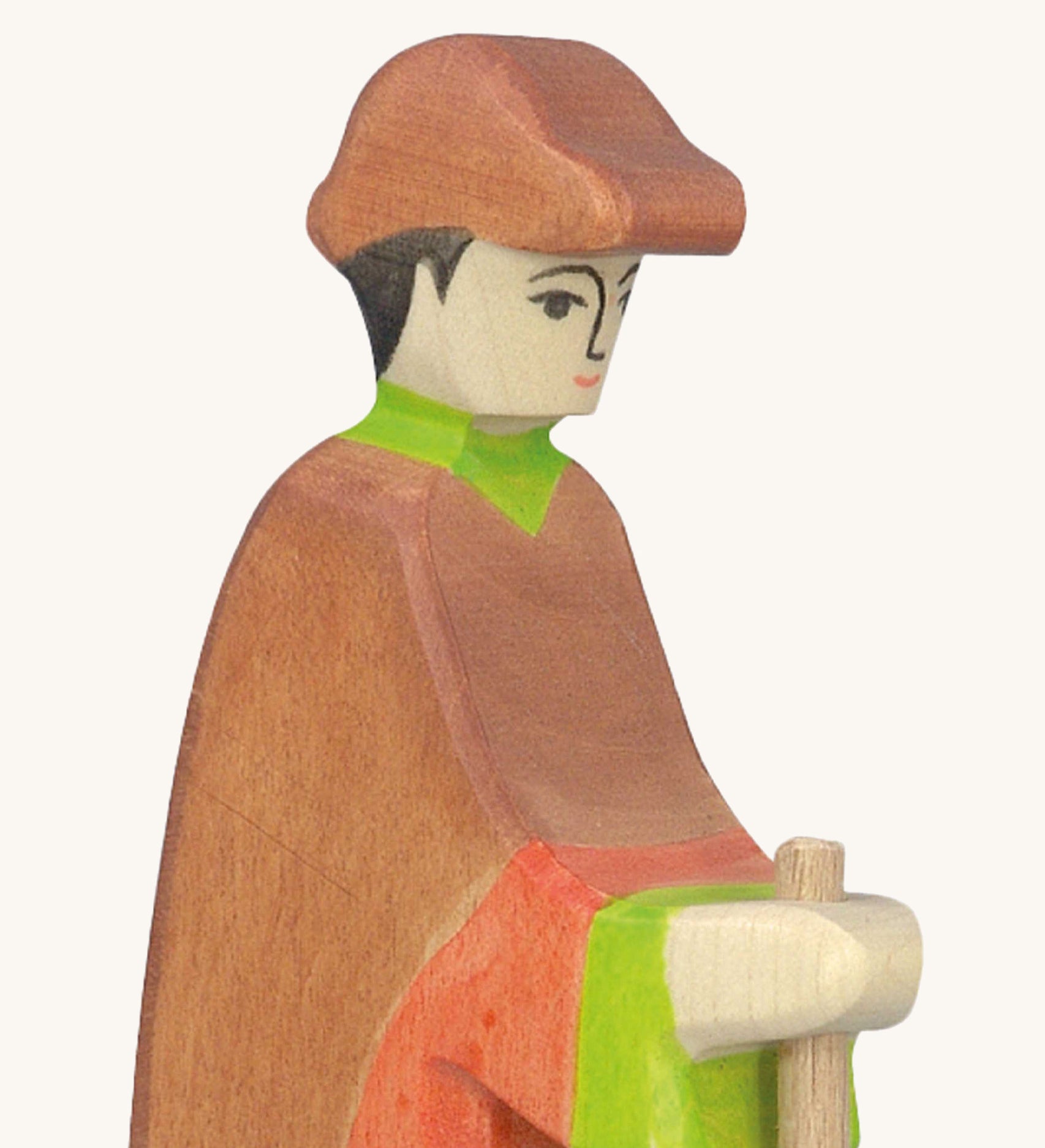 A close up of the wooden Holztiger wooden shepherd figure showing the hand painted detail on the face and the brown cap on the head