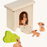Holztiger small handcrafted wooden stable with the roof on, front door pulled down with wooden rabbit animal figures inside