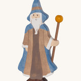 Holztiger wooden bearded magician figure with a blue cloak and brown outfit with a matching blue hat and holding a wooden staff