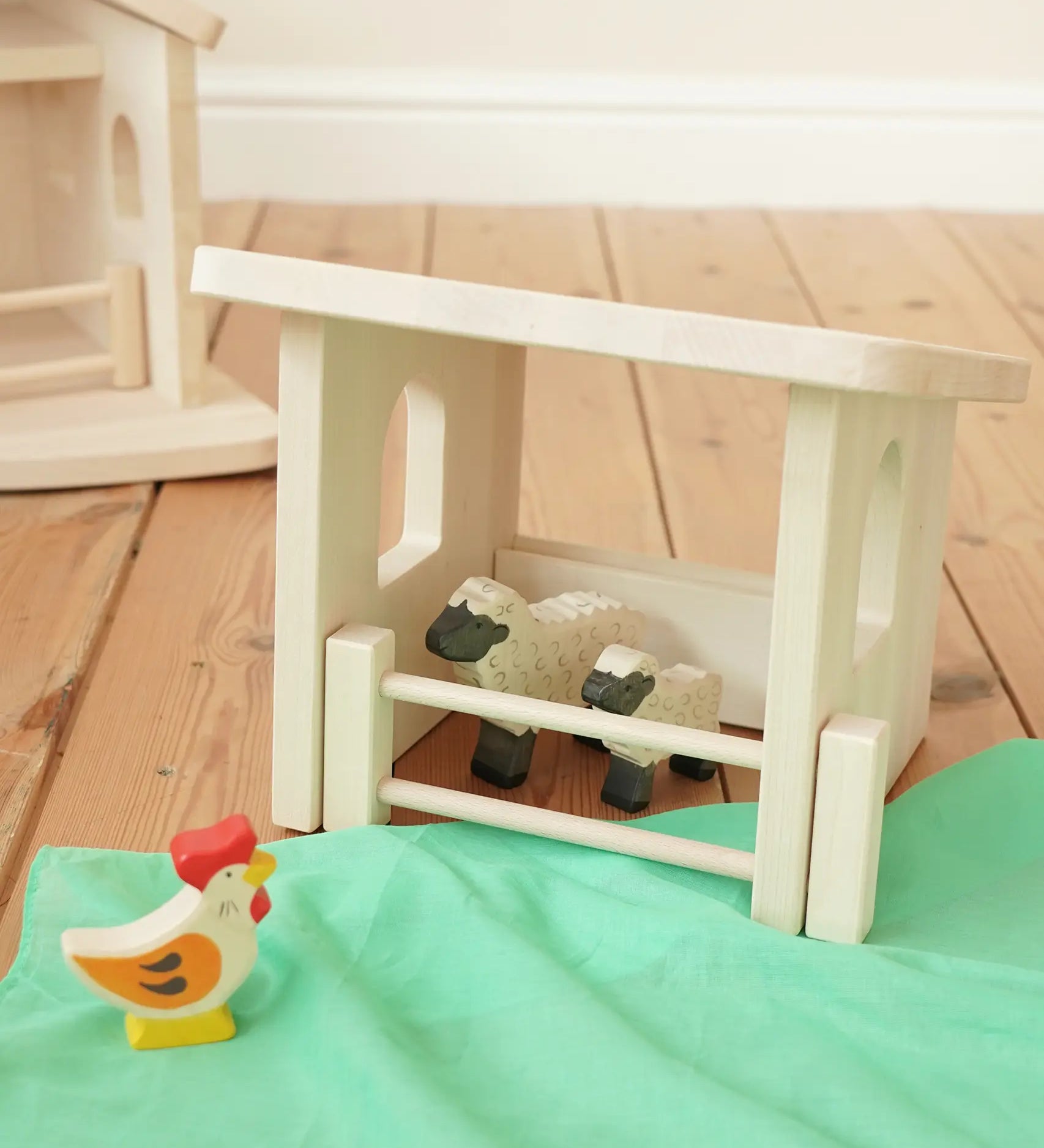 Holztiger wooden shelter toy for farm animals with moving fence door and a Holztiger sheep and lamb.