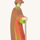 Holztiger wooden shepherd figure made from natural wood with a painted red and brown outfit with a brown hat and holding a wooden staff