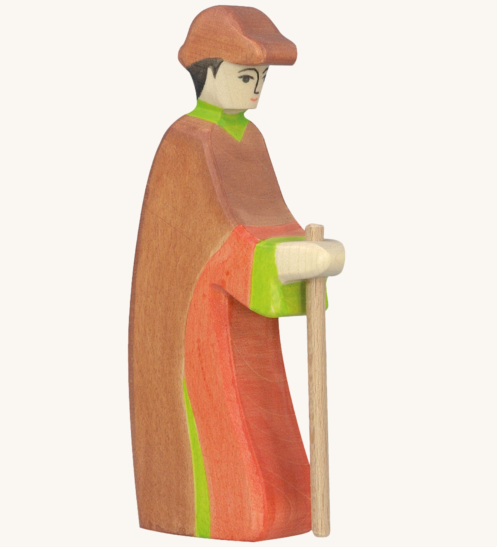 Holztiger wooden shepherd figure made from natural wood with a painted red and brown outfit with a brown hat and holding a wooden staff