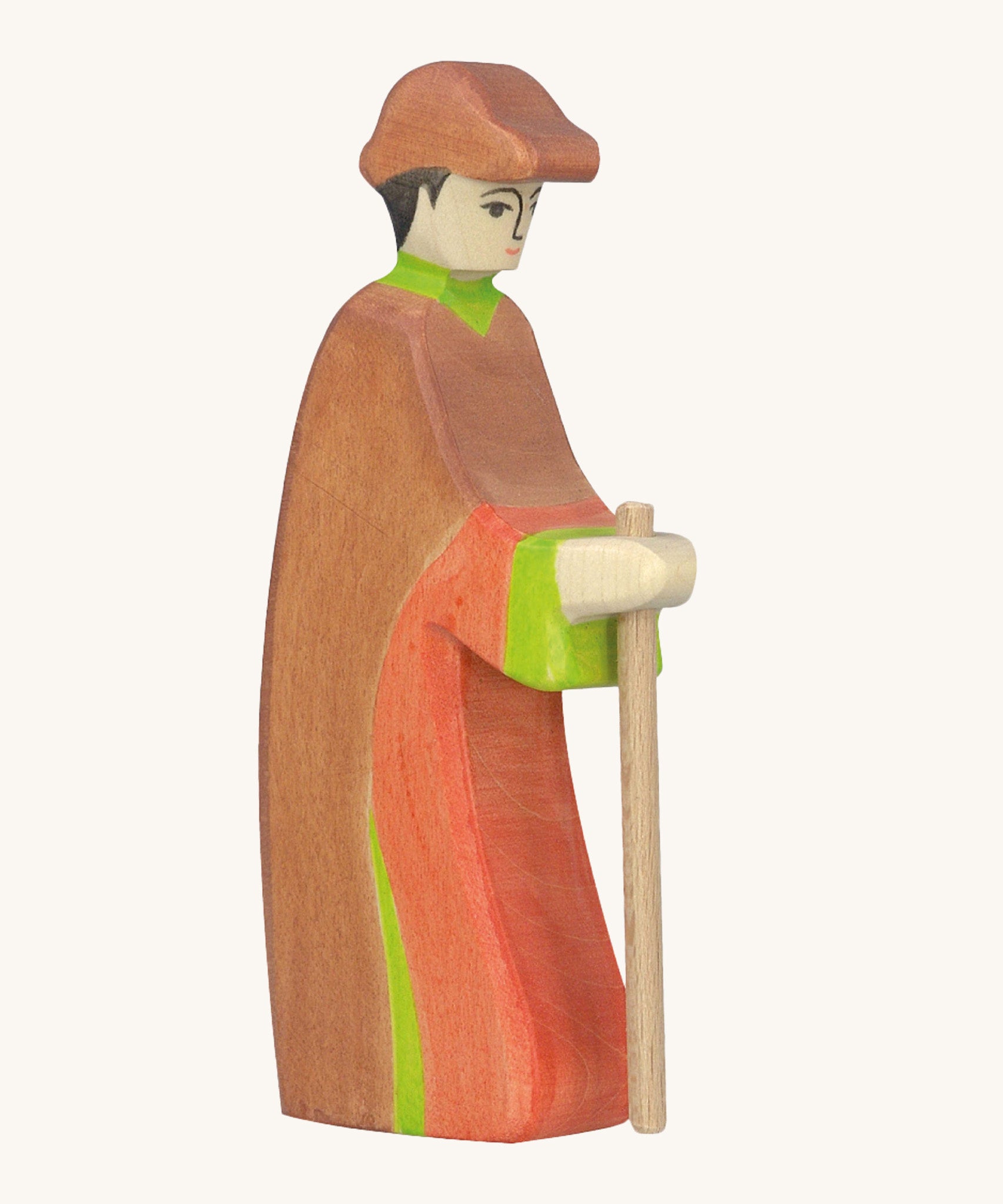 Holztiger wooden shepherd figure made from natural wood with a painted red and brown outfit with a brown hat and holding a wooden staff