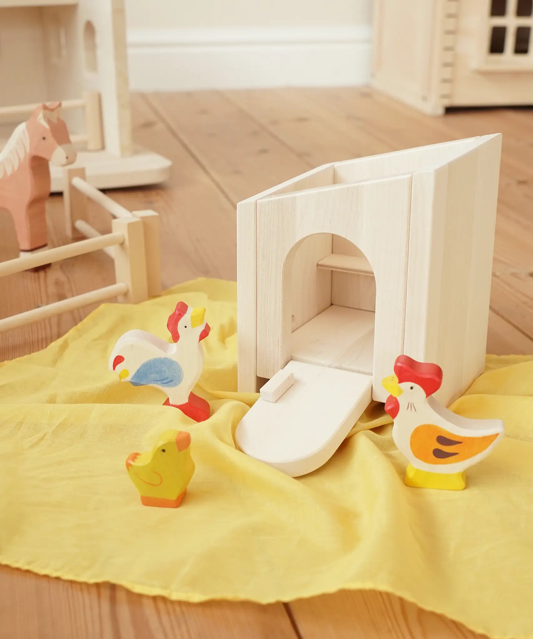 Holztiger wooden small animal shelter toy used as a chicken coop with Holztiger hen, chick and cockerel. 