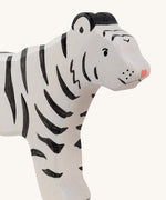 A close up of the Holztiger wooden standing white adult tiger with black stripes showing the hand painted facial features