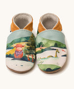 Inch Blue highland cow shoes available at Babipur. A soft baby leather shoe with a playful highland cow and the loch ness monster design. Features elastic ankle cuffs for a secured fit