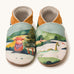 Inch Blue highland cow shoes available at Babipur. A soft baby leather shoe with a playful highland cow and the loch ness monster design. Features elastic ankle cuffs for a secured fit