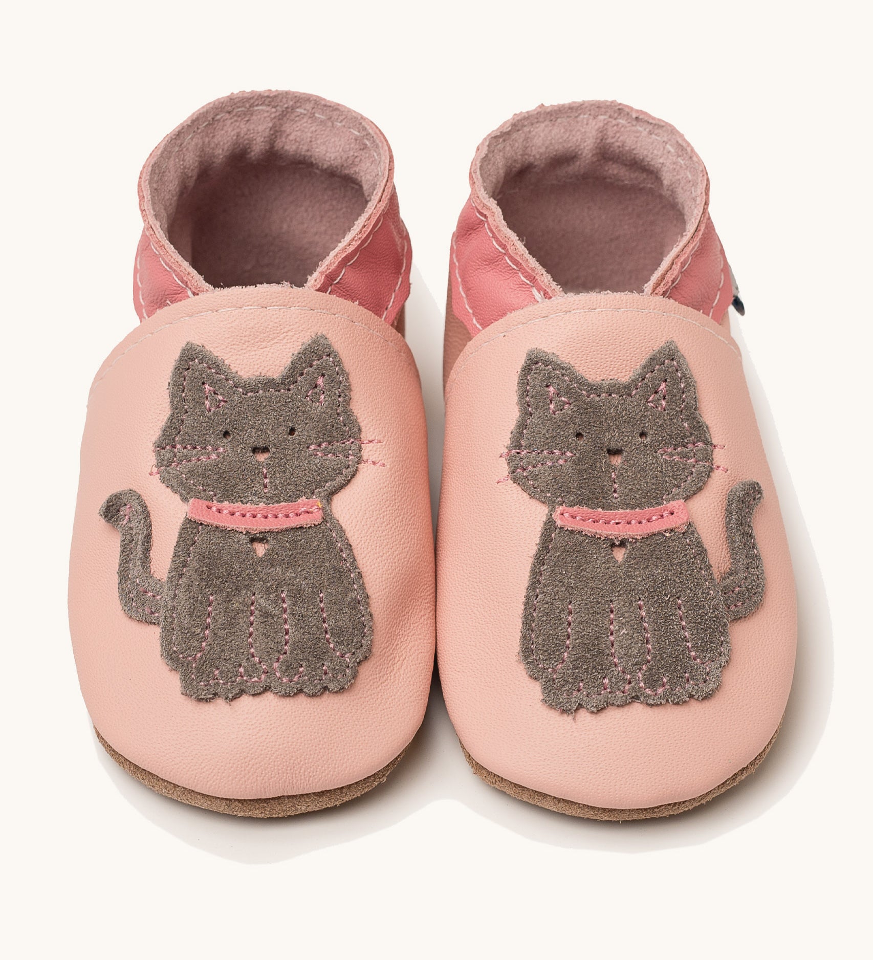 Inch Blue meeow soft pink  baby shoes available at Babipur. A soft light pink leather baby shoe with a cute playful grey suede cat on each shoe. Features elastic ankle cuffs for a secured fit