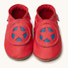 Inch Blue superkid red baby shoes available at Babipur. A soft red baby leather shoe with a red and blue star shield design on each shoe. Features elastic ankle cuffs for a secured fit