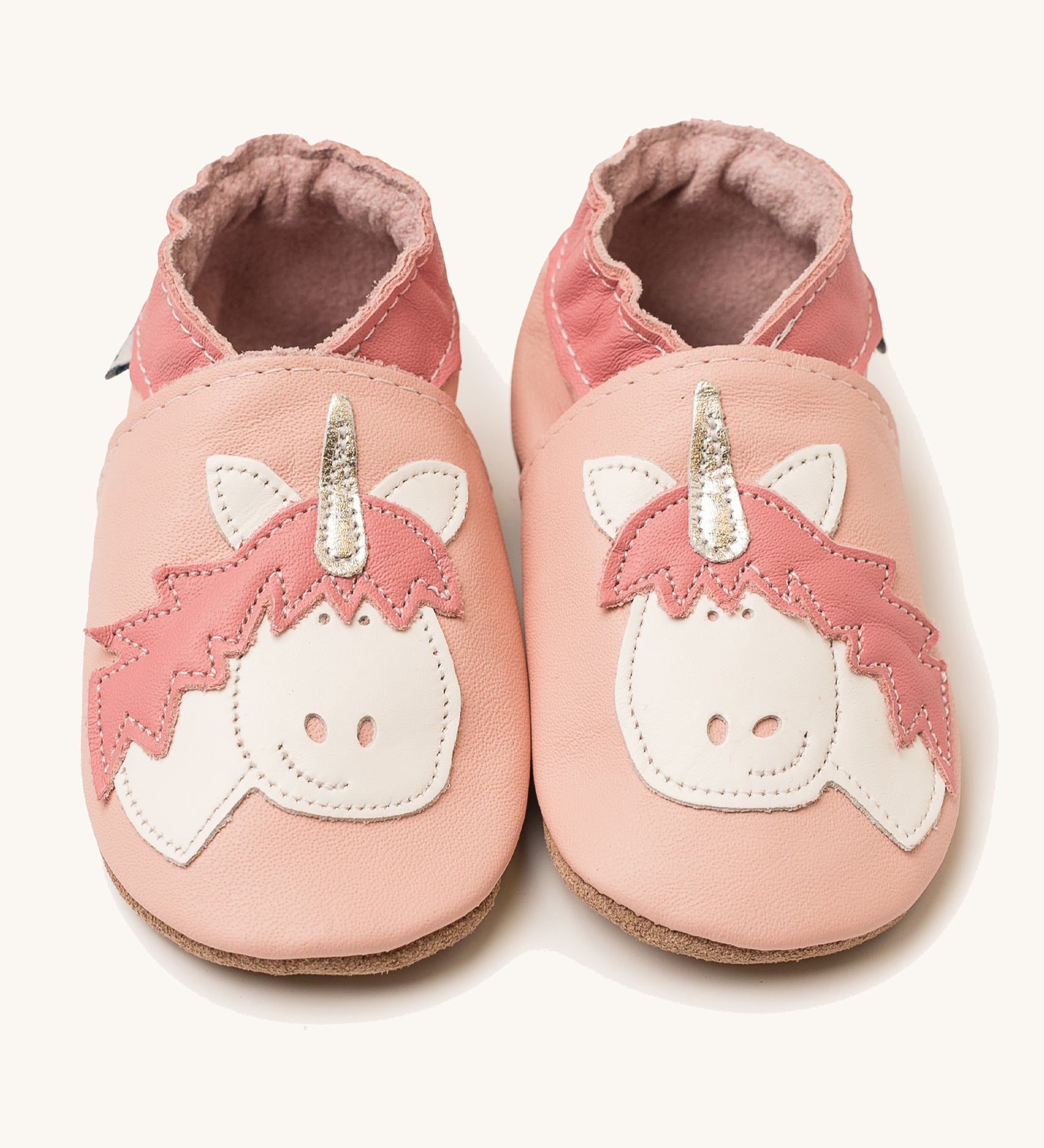 Inch Blue pink unicorn baby shoes available at Babipur. A light pink baby leather shoe with a cute playful white unicorn on each shoe. Features elastic ankle cuffs for a secured fit