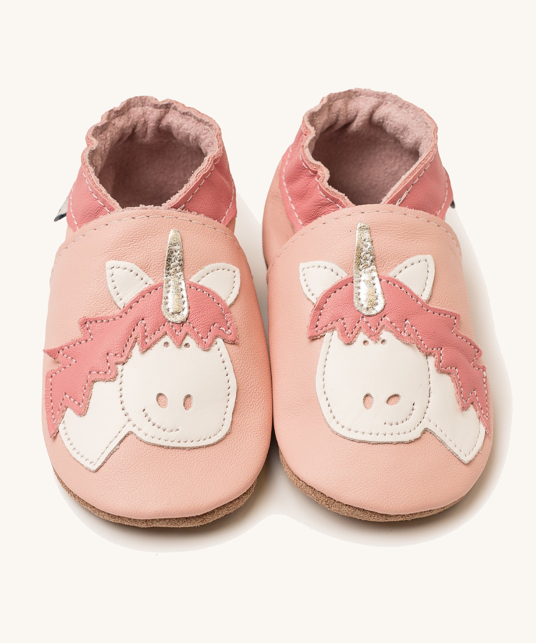 Inch Blue pink unicorn baby shoes available at Babipur. A light pink baby leather shoe with a cute playful white unicorn on each shoe. Features elastic ankle cuffs for a secured fit