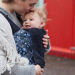 A person baby wearing a child in an integra carrier