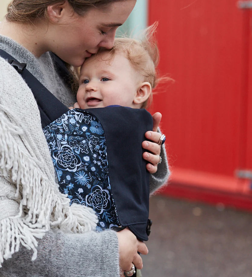 A person baby wearing a child in an integra carrier