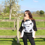 A person baby-wearing a child in an Integra Size 2 Carrier whilst outside