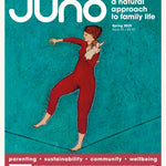 Cover of Juno Magazine Issue 95 Spring 2025. The artwork of this natural parenting magazine features an oil painting of a lady holding a naked baby on a tight rope.