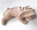 Kathe Kruse holly lying rabbit comforter with small white waldorf doll on the back wrapped in the muslin bib