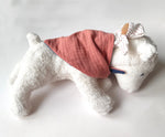 Kathe Kruse white lying lamb comforter with small white waldorf doll on the back wrapped in the muslin bib