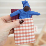 Kathe Kruse baby Waldorf Doll black skin with sleeping bag in red check.