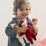 Child holding three Kathe kruse Lolo Waldorf dolls