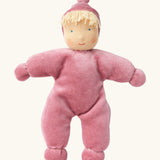Kathe Kruse Lolo Rose waldorf doll showing a light pink towelling outfit, light skin and yellow hair.