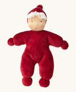 Kathe Kruse Lolo Ruby Waldorf doll showing a red towelling outfit, light skin and white hair.