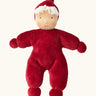 Kathe Kruse Lolo Ruby Waldorf doll showing a red towelling outfit, light skin and white hair.