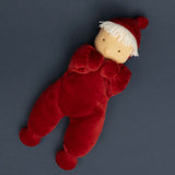 Kathe Kruse Lolo Ruby Waldorf doll lying on a navy surface