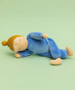 Kathe Kruse cloud nana waldorf doll lying on a green surface