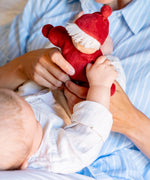 Mother and baby playing with Kathe Kruse Lolo Ruby Waldorf doll showing its red outfit and white hair