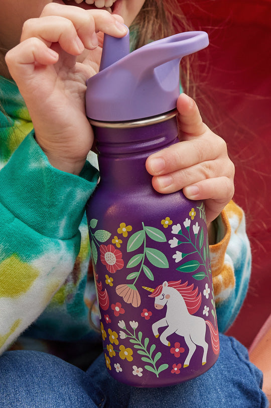 Child holding a reusable Kid Kanteen bottle with leakproof cap in purple with a floral and unicorn print, to represent Kid Kanteen range at Babipur, official UK stockist.