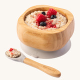 Porridge topped with fresh berries in the Eco Rascals Bamboo Bowl & Spoon Weaning Set in grey silicone.