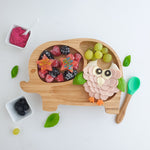 Elephant bamboo baby weaning plate with frozen berries and bamboo baby spoon.