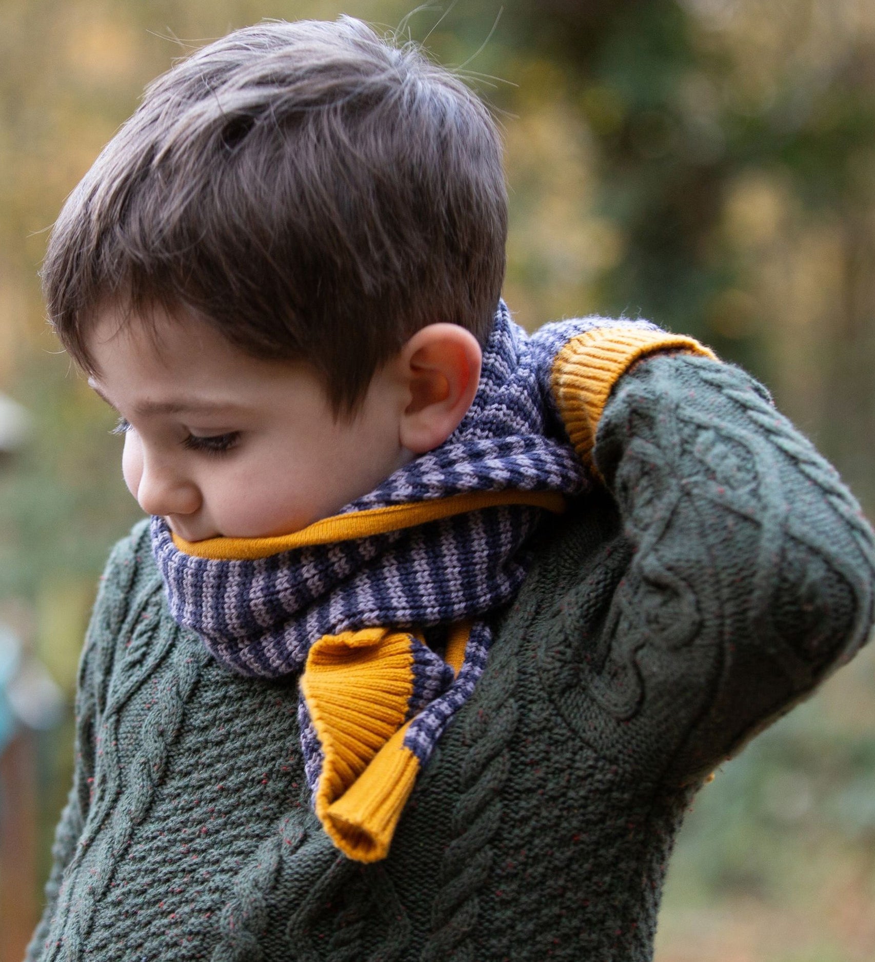 A child wearing the LGR lovely Dreamy Blue Stripe scarf and mittens