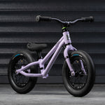 A closer look at the Early Rider Charger Balance Bike - Violet Haze from the front and side, on a grey background