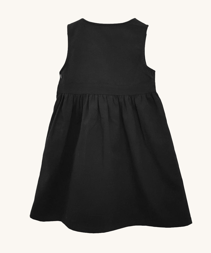 The back of the Eco Outfitters organic and fair trade cotton school pinafore dress in black.